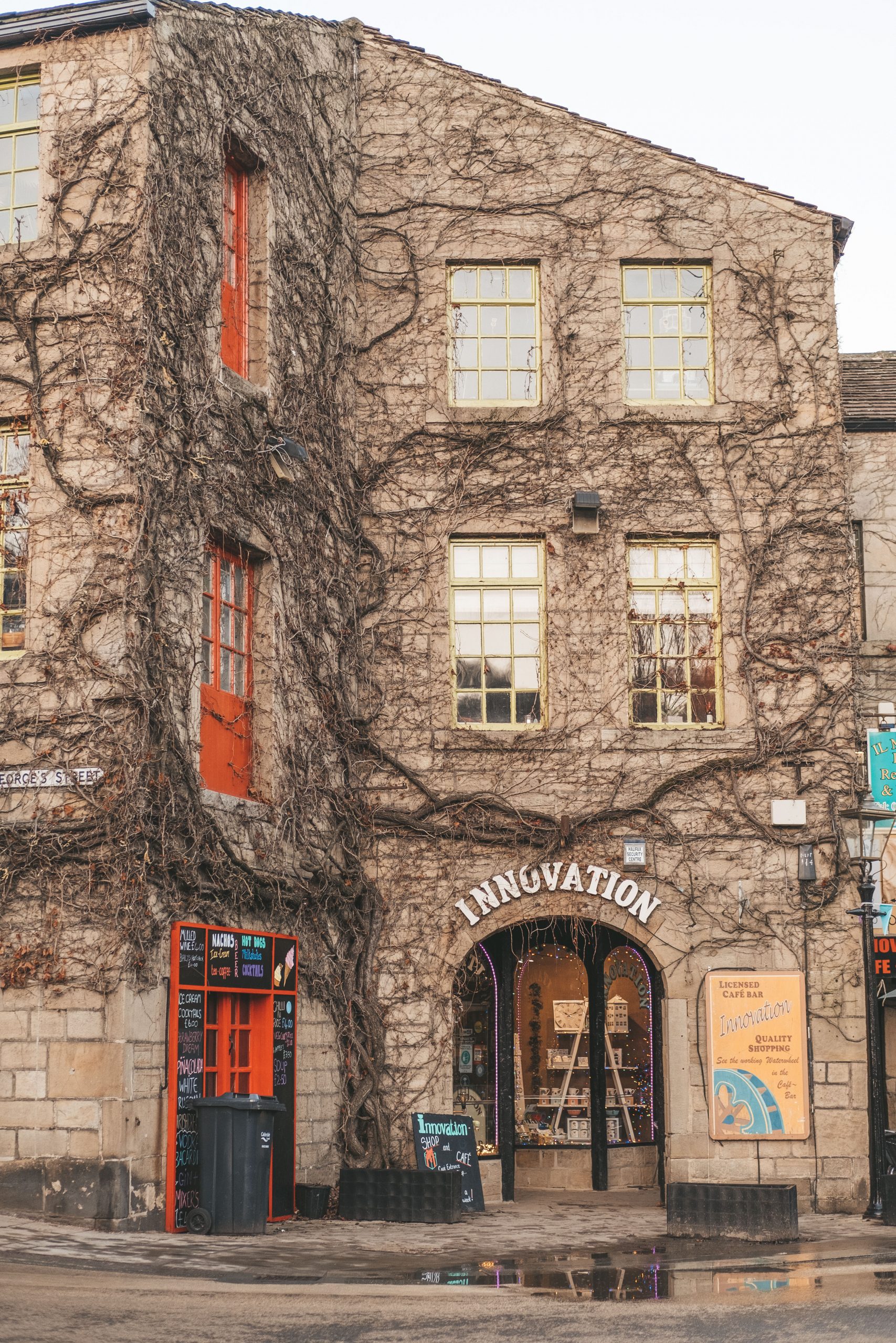 Bright and lively building in Hebden Bridge covered in ivy roots during winter