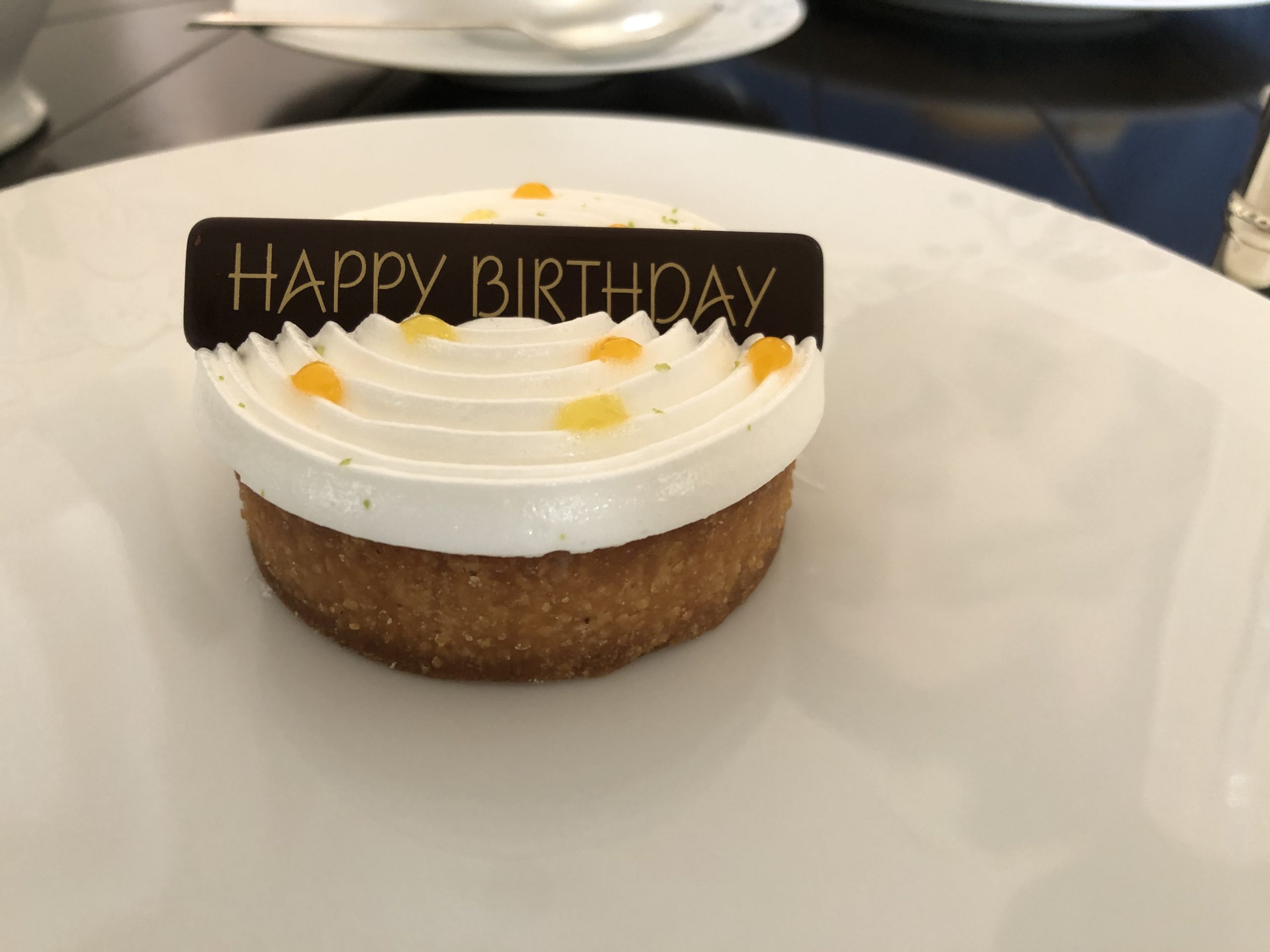 Cake at the Singapore Raffles with happy birthday chocolate plaque