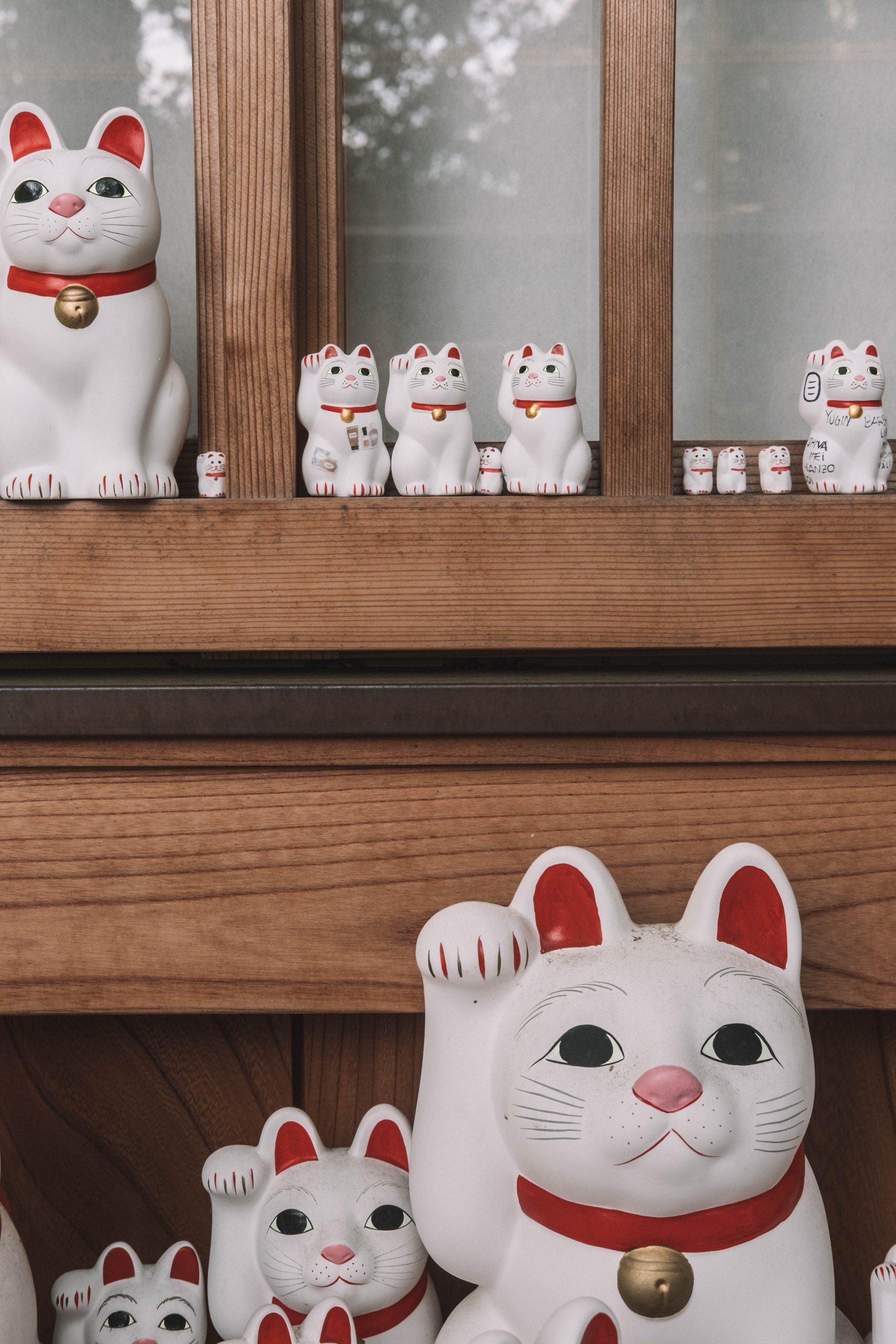 Cat figurines with messages on them at Gotokuji temple