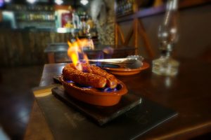 Chorizo on flames in Madeira - a delicious food in Madeira you need to try