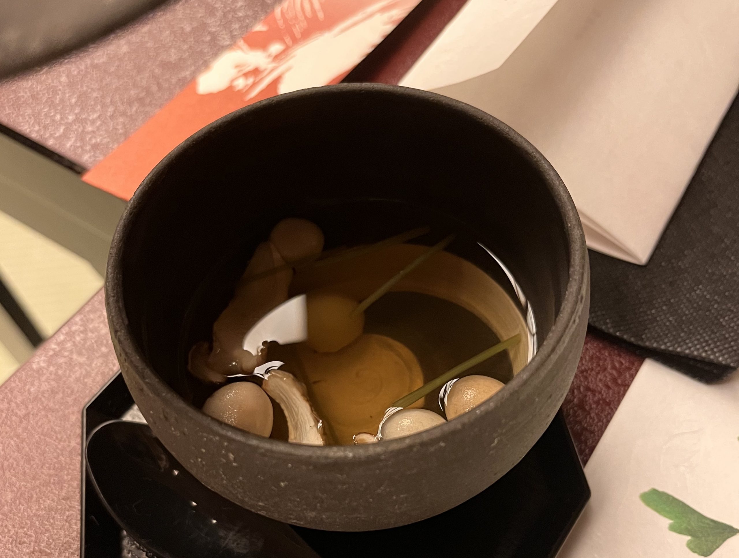Clear miso with mushrooms and clams at Nishiyama onsen in Japan Clear miso with mushrooms and clams at Nishiyama onsen in Japan