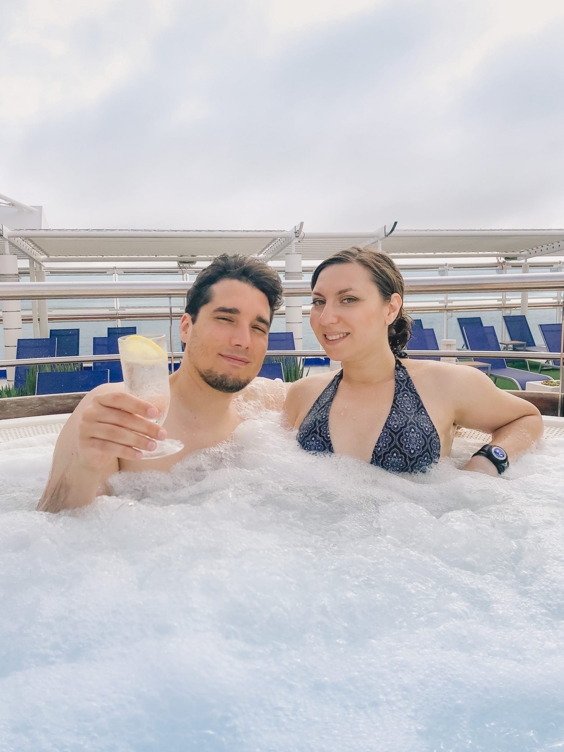 Cory and G chilling in the hot tub with cocktails