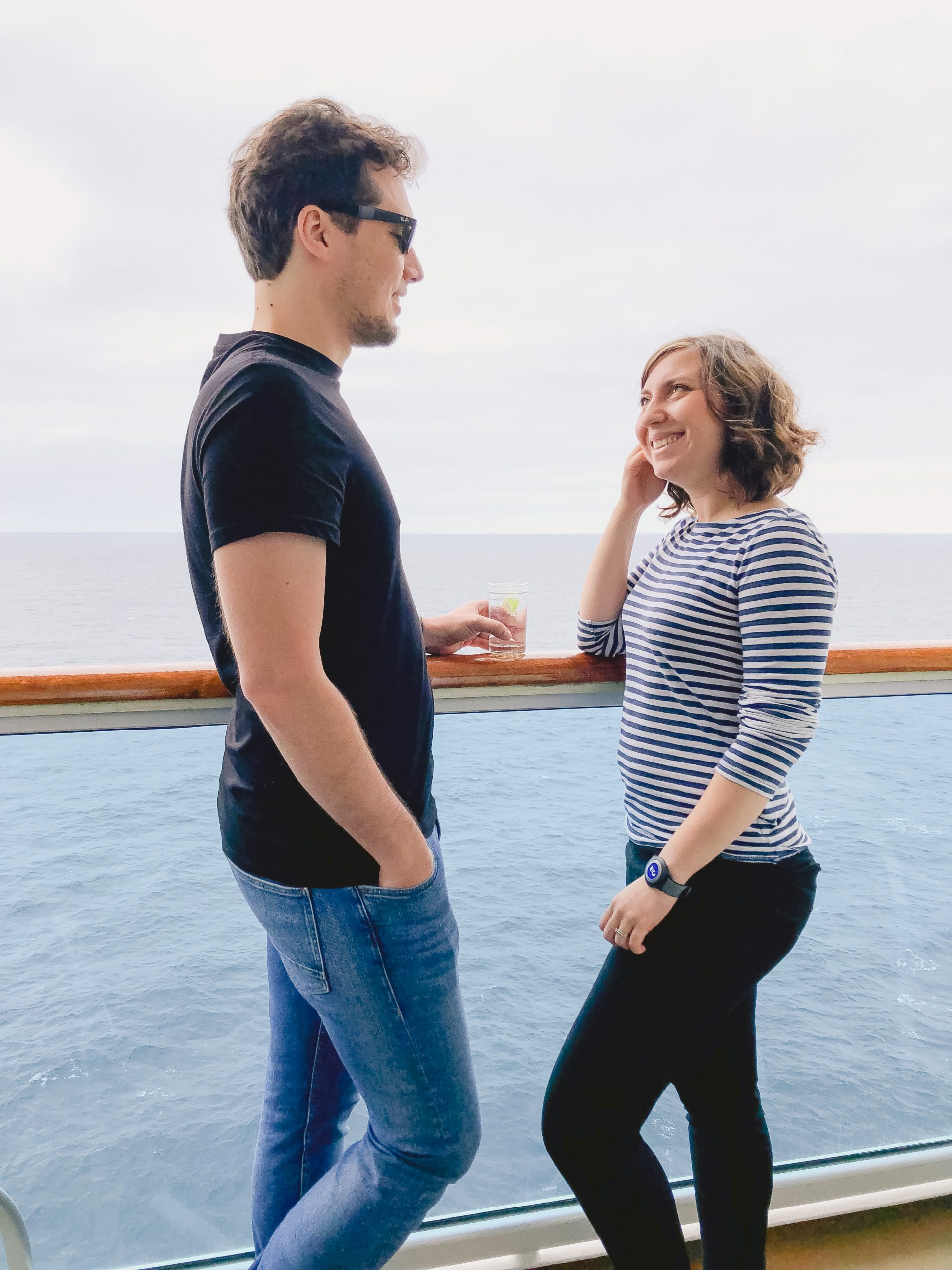 Cory and G sipping cocktails on their balcony in their stateroom on Regal Princess Cruise