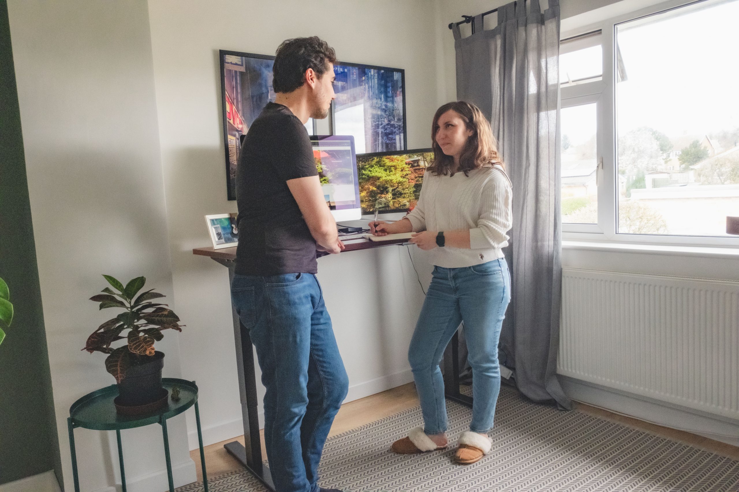 Cory and Greg collaborating at their standing desk at home