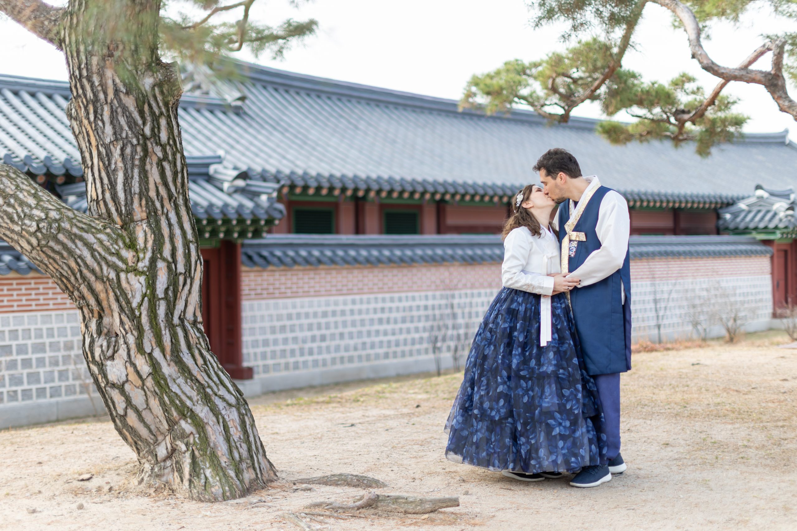 Cory and Greg from You Could Travel wearing Hanbok and kissing in Seoul