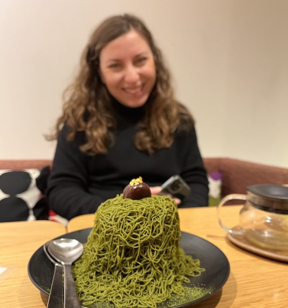 Cory from You Could Travel enjoying her matcha mont blanc cake in Lumine Est