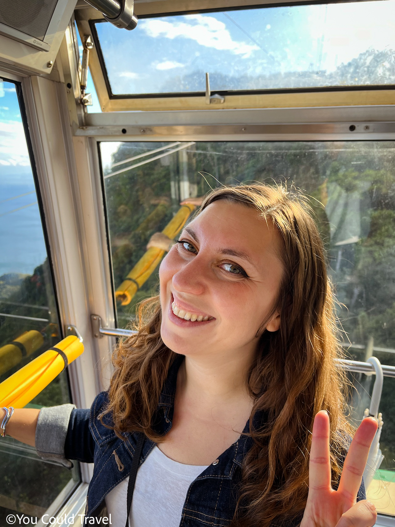 Cory from You Could Travel taking the ropeway from Mount Misen