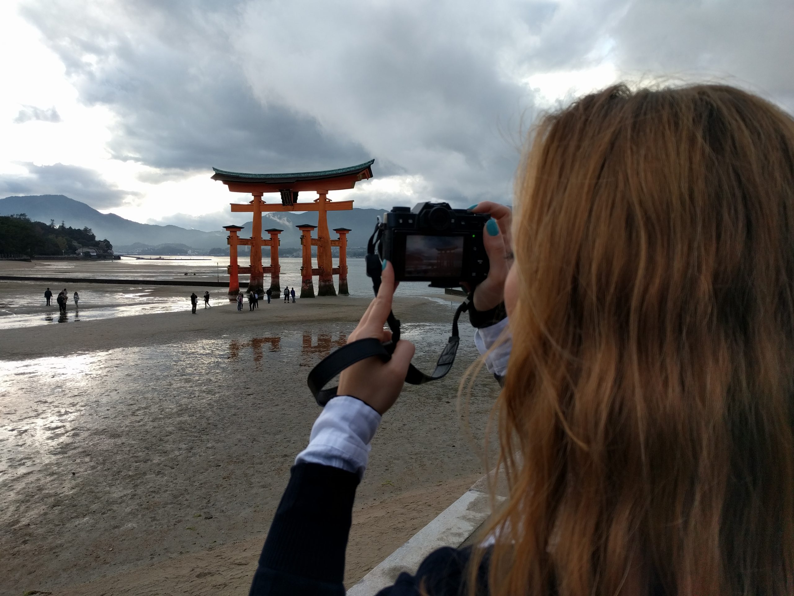Cory photographing the Itsukushima shrine in Japan