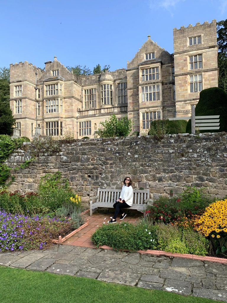 Cory sitting on a bench at the fountains abbey