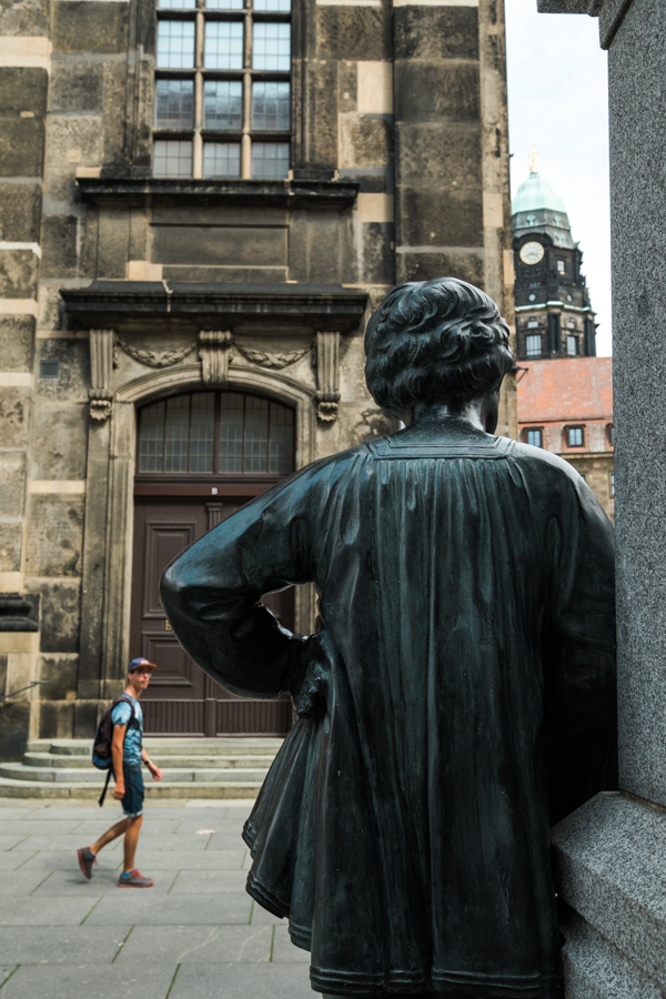 Dresden statues looking at a person walking by