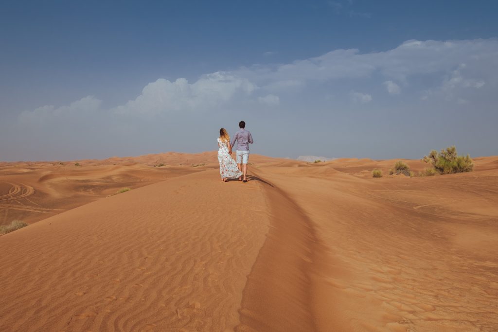 Cory and Greg exploring the dunes as part of their Dubai Itinerary