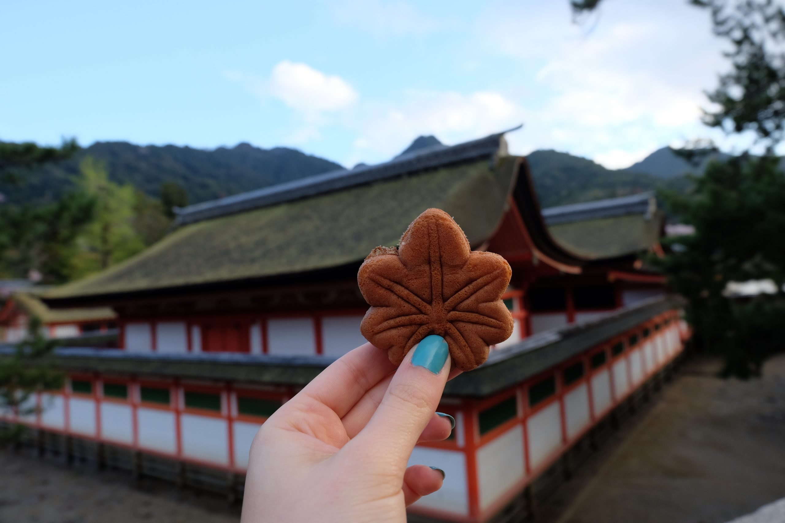 Eating lots of street food in Japan - try the Momijimanju on Miyajima island