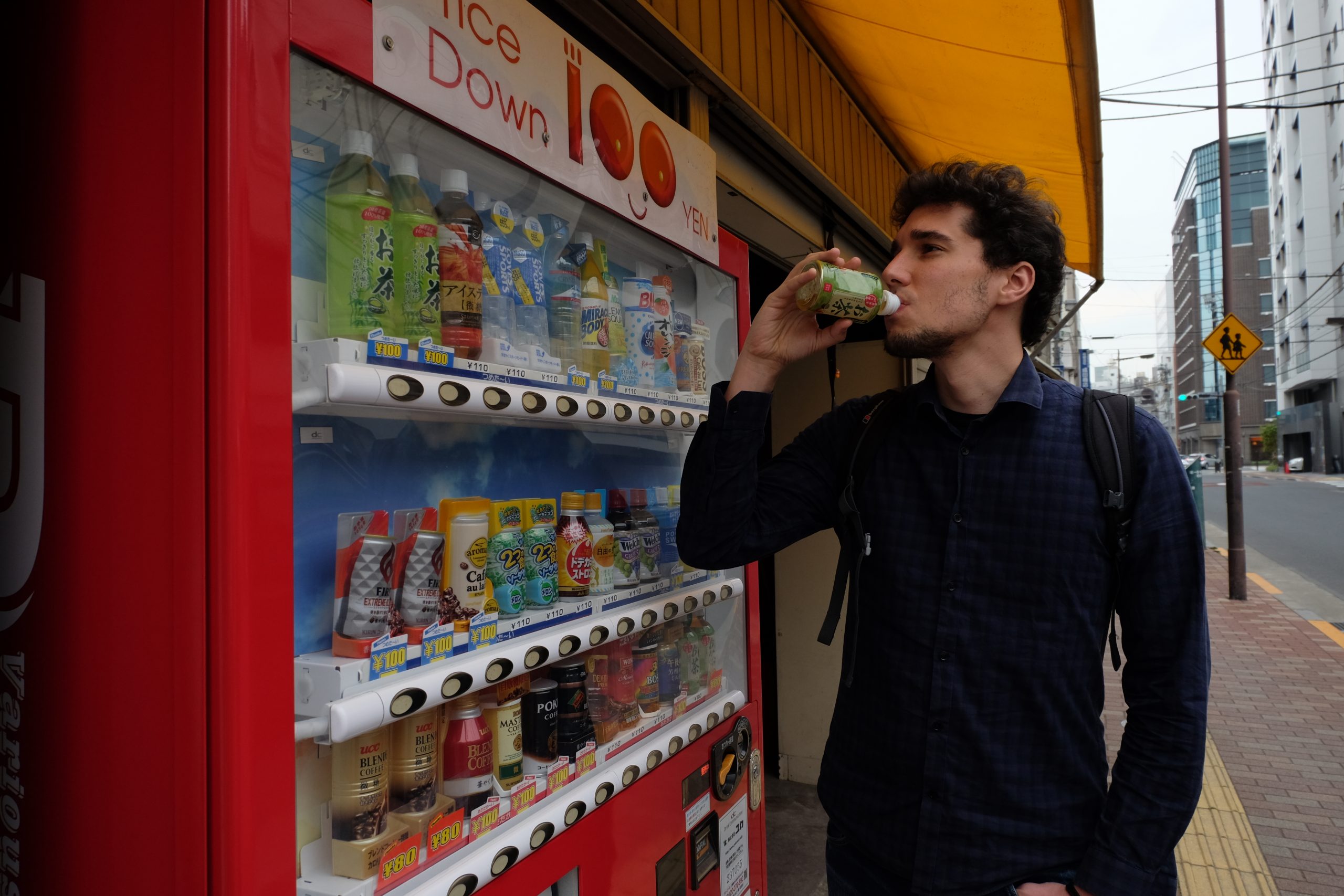 G from You Could Travel drinking tea from a Japanese vending machine