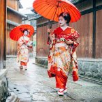 Geisha walking in Kyoto in the rain