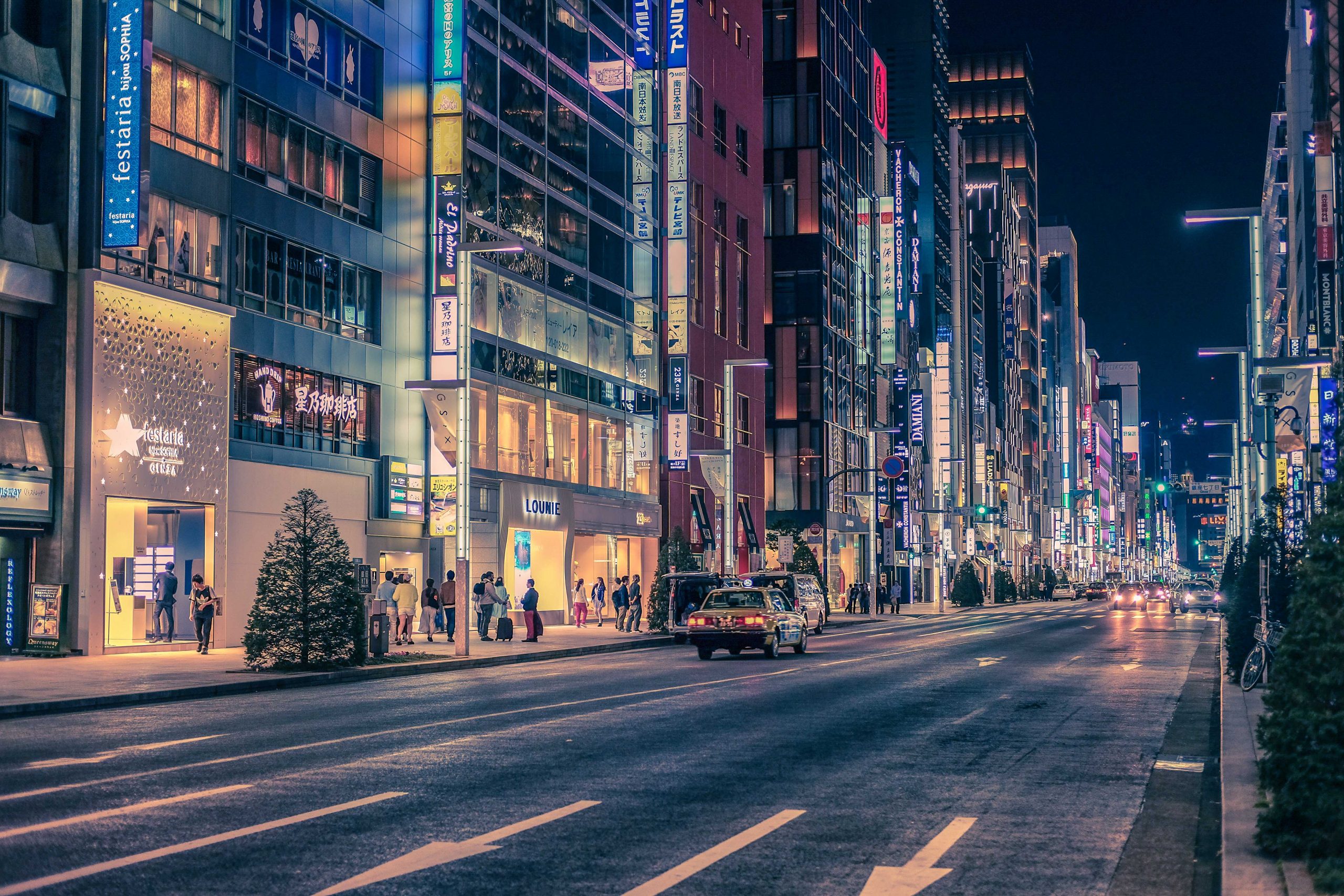 Ginza road at night time lined with shops and restaurants