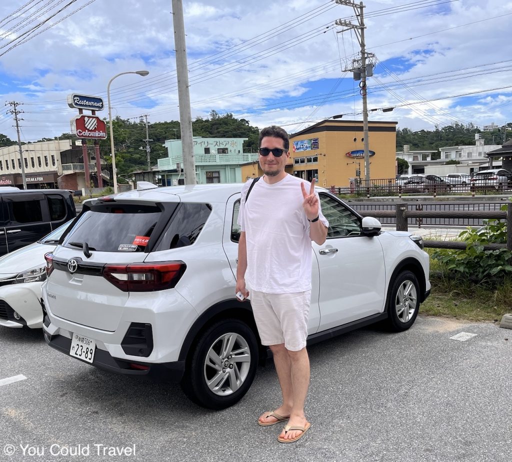 Greg from You Could Travel in front of our rentailcar in Okinawa