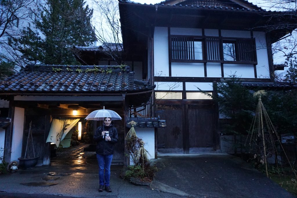 Greg posing in front of a ryokan at the Snow Monkey Park