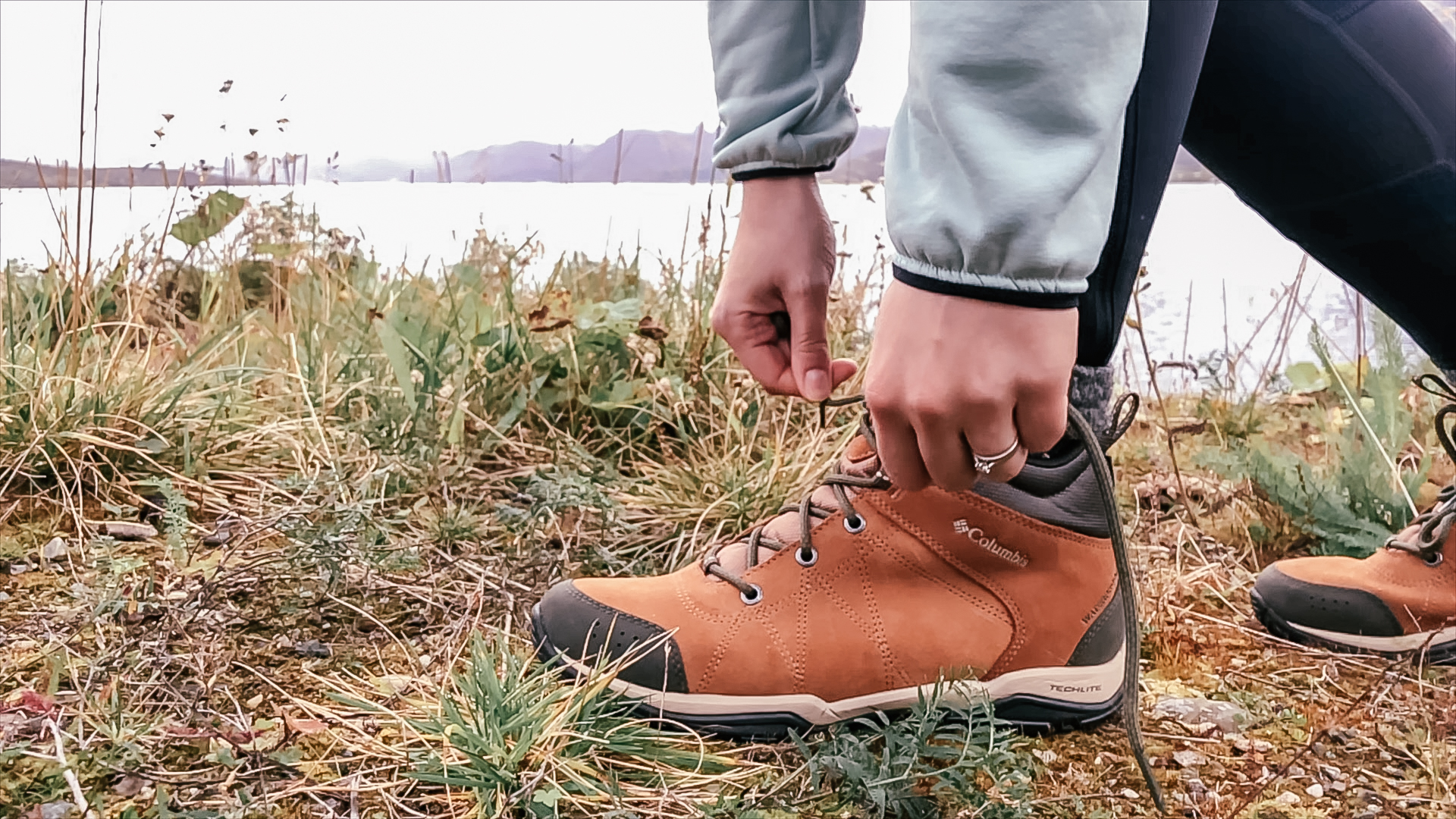 Woman tying her laces on her Columbia boots - one of the best walking boots for women in the market