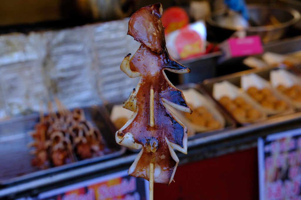 Ikayaki grilled squid in Tokyo Ikayaki on a stick served as street food in Japan