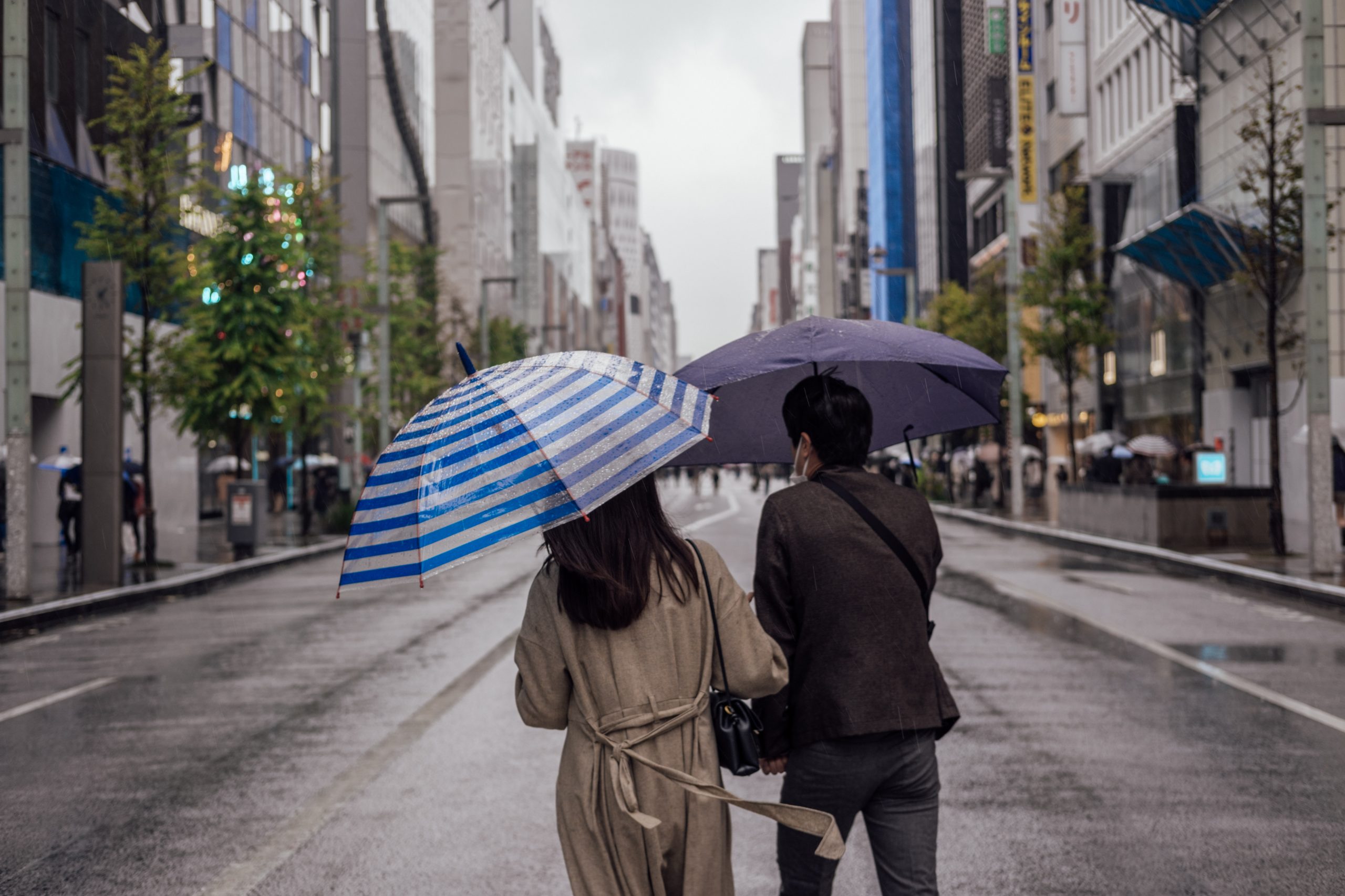 Japanese couple walking on Chuo Dori Ginza on the weekend