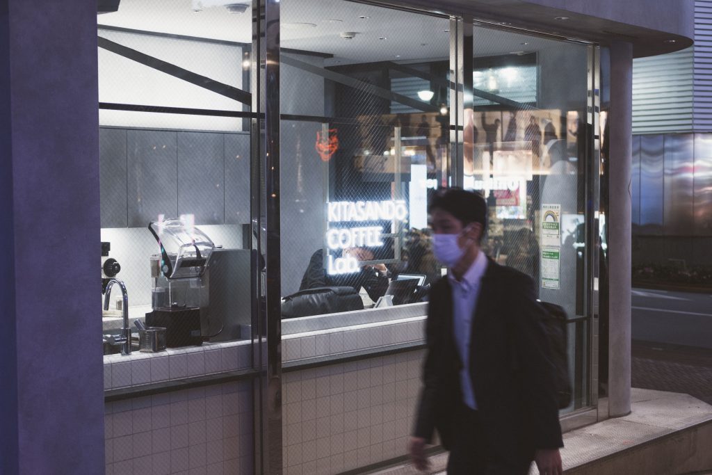 Japanese salaryman passing a local coffee joint in Shibuya