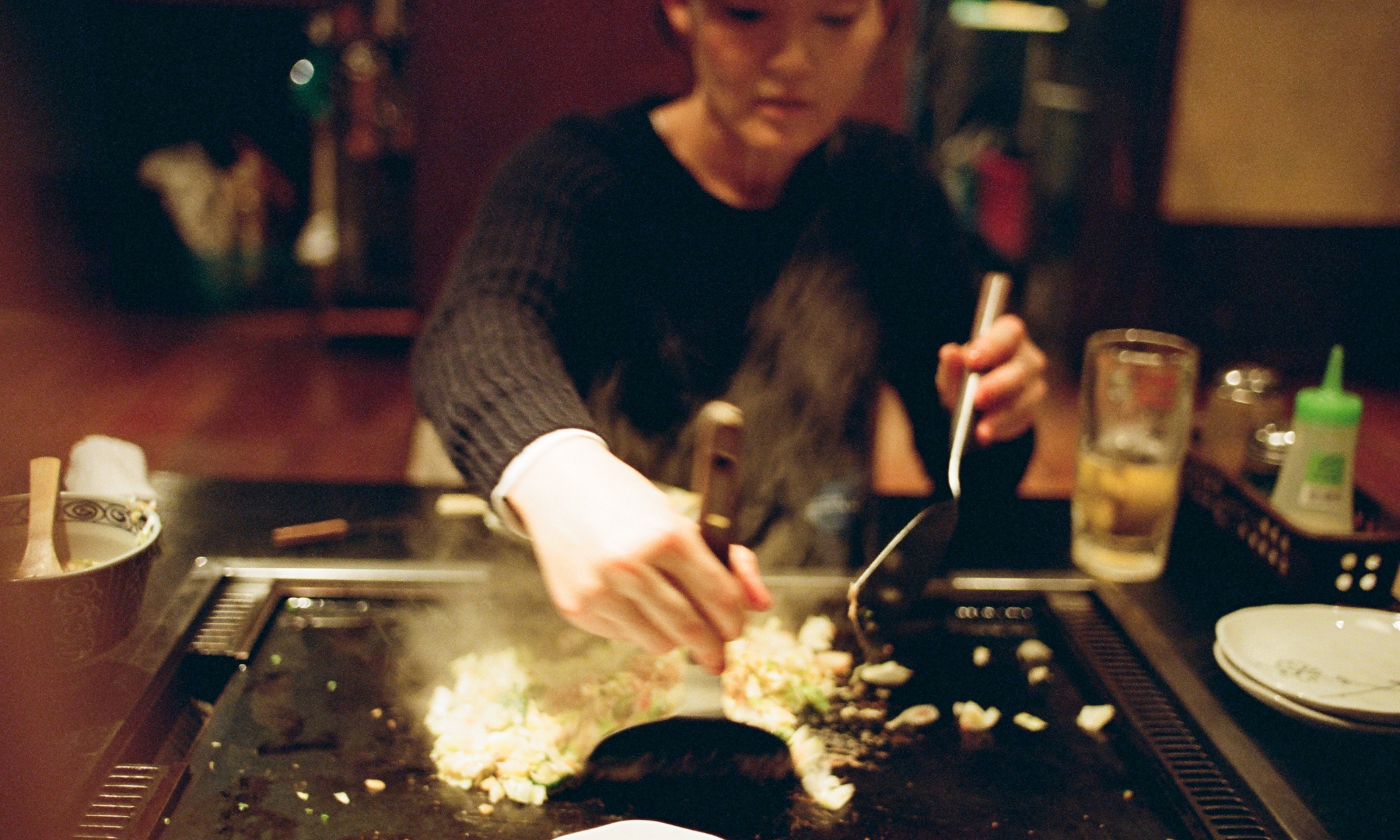 Japanese woman cooking Monjayaki Tsukishima Monja Dori