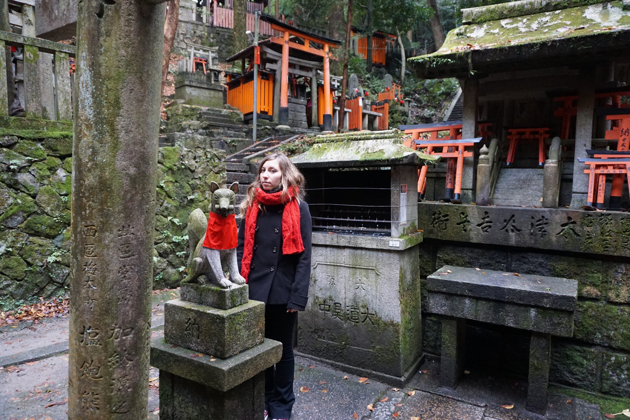 Kitsune at Fushimi Inari shrine holding a scroll in its mouth