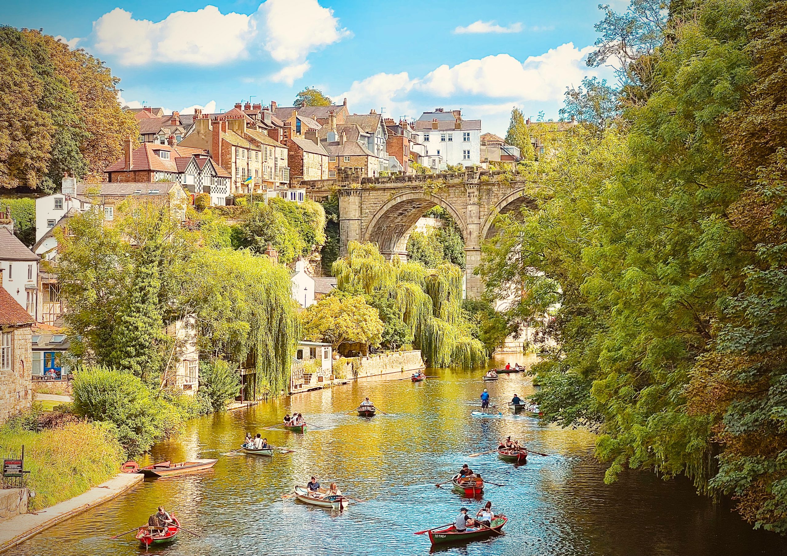 Tourists rowing under the Railway viaduct in Knaresborough