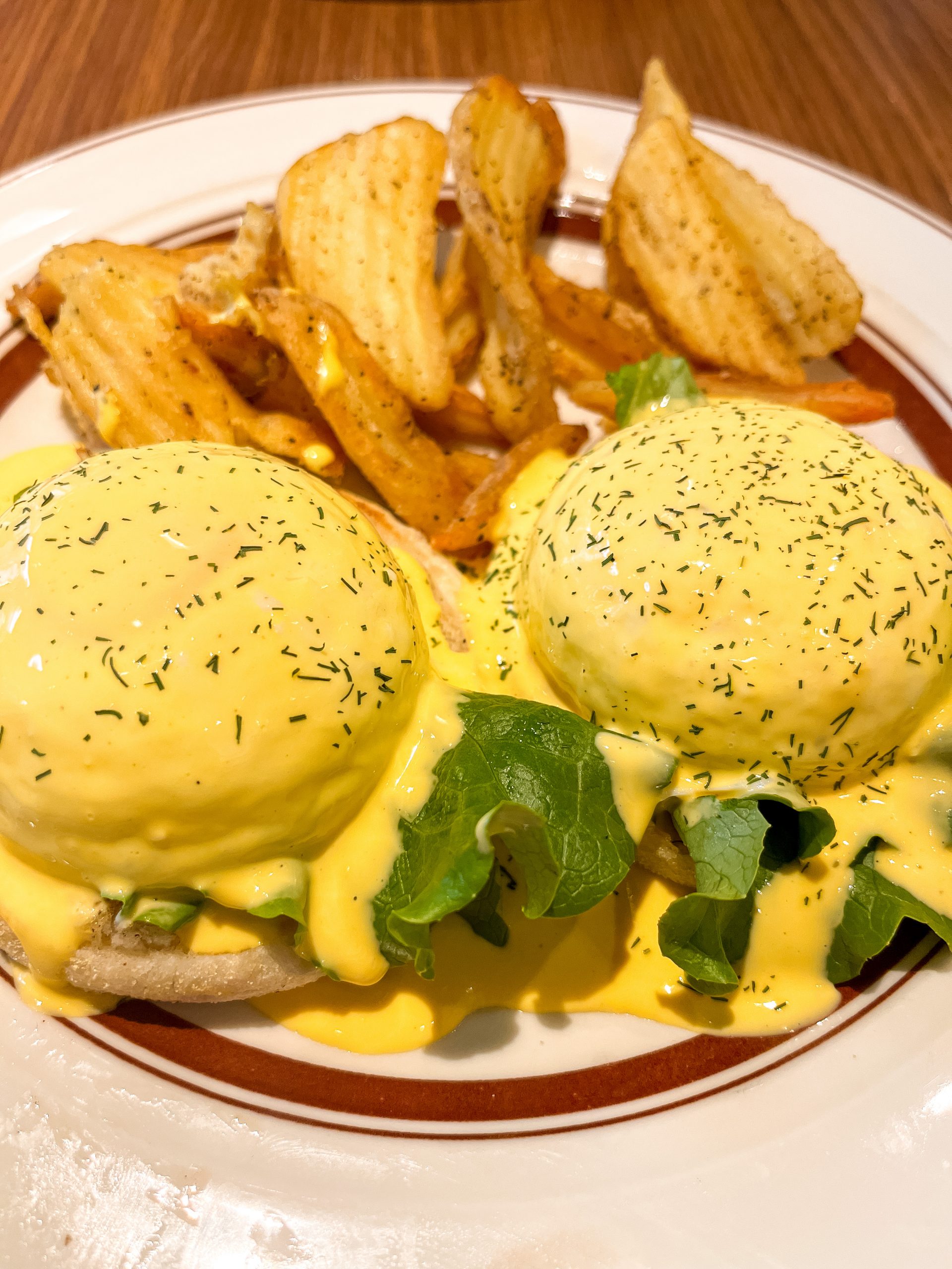 Large portion of poached eggs with potatoes on side