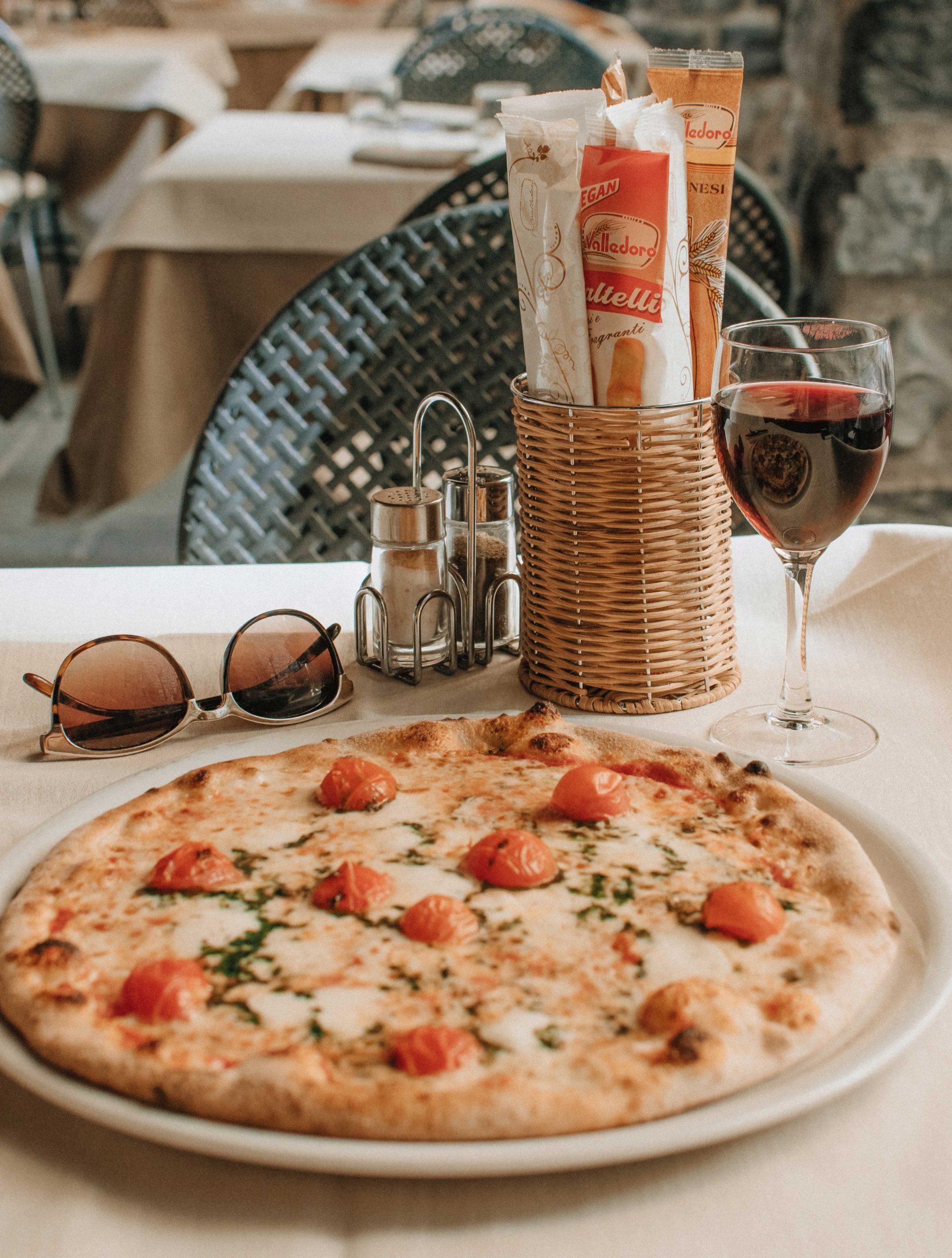 Local glass of red wine with a delicious pizza, Bellagio Italy