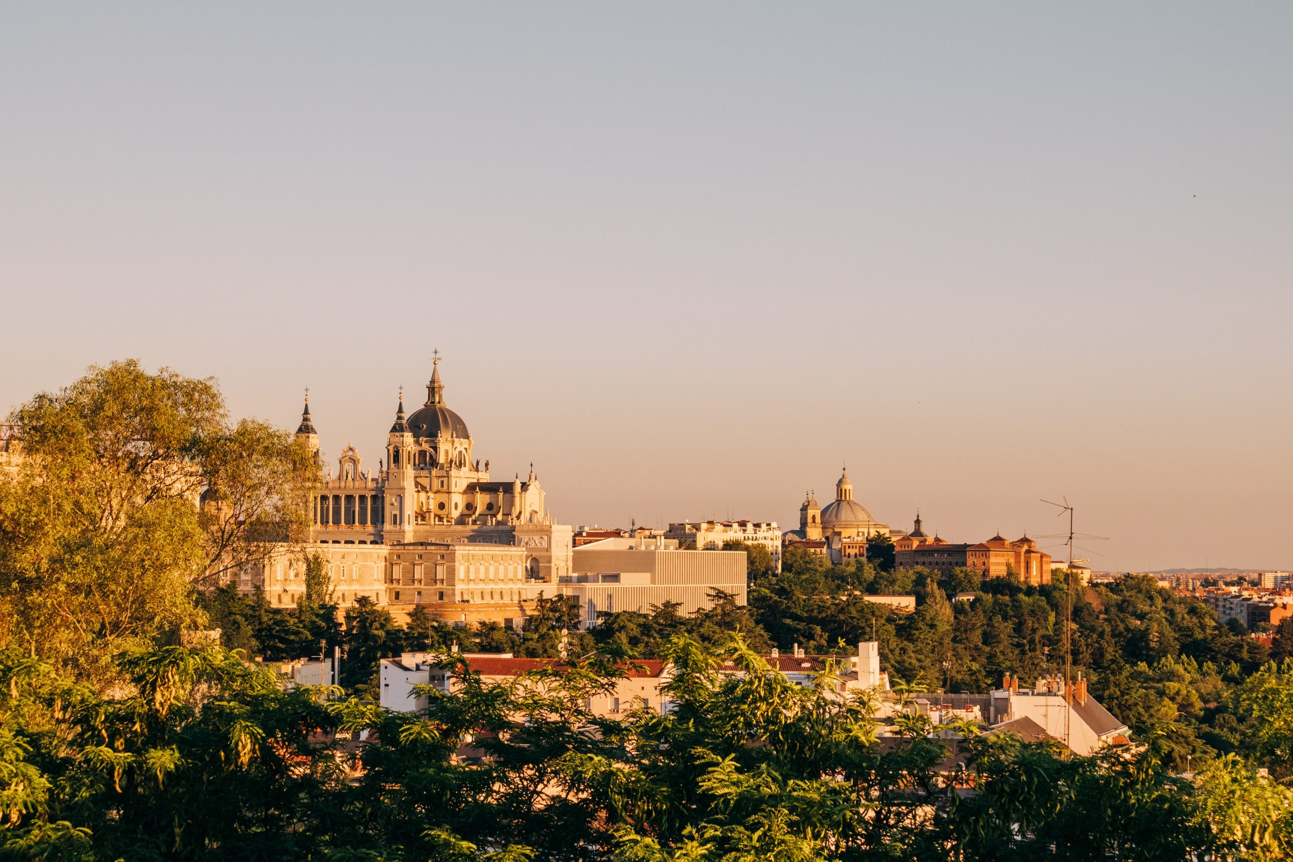 Madrid during sunset with leafy districts - one of the best places to stay