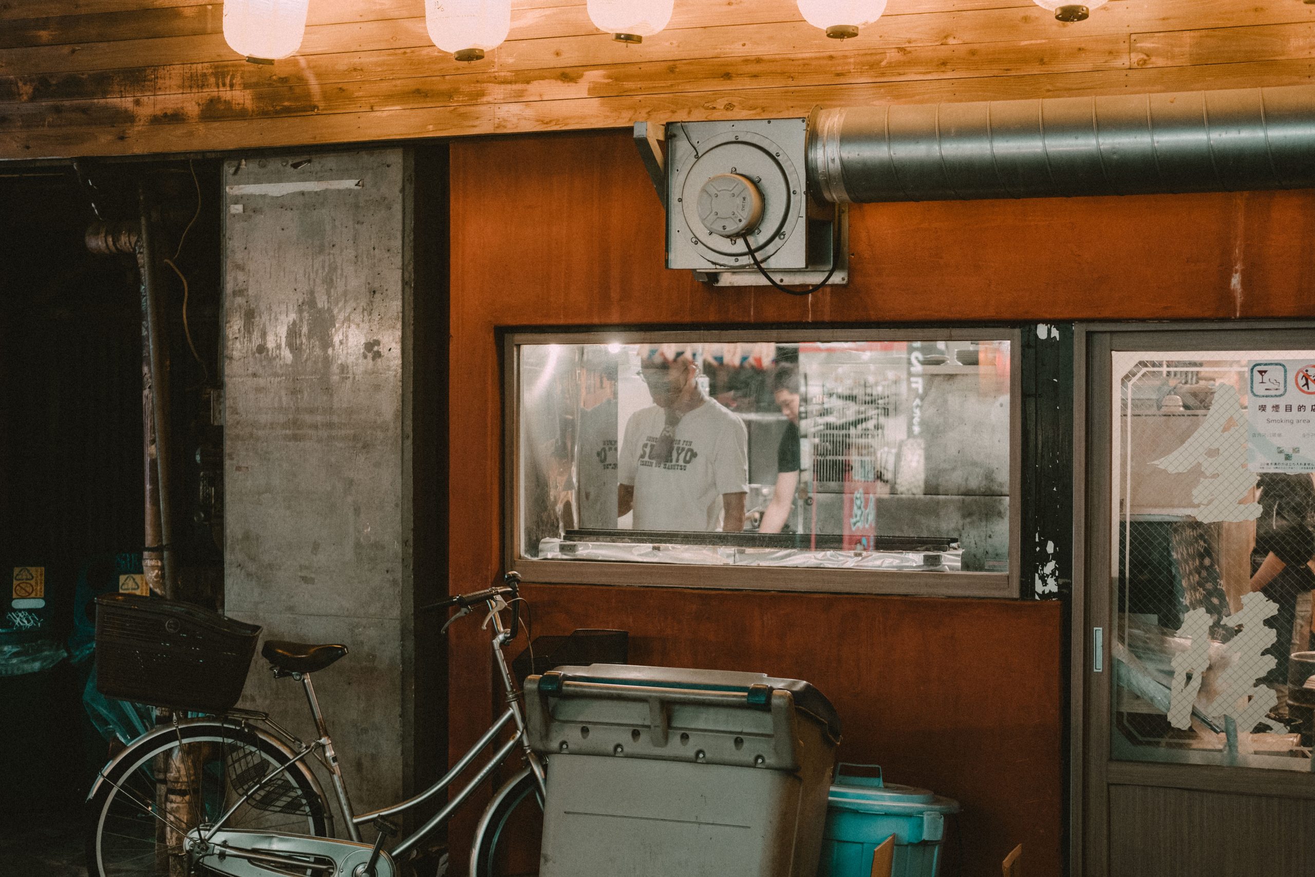 Man cooking in an Izakaya in Yokocho Man cooking in an Izakaya in Yokocho