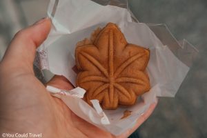 Cory holding a Momiji manju snack from Miyajima