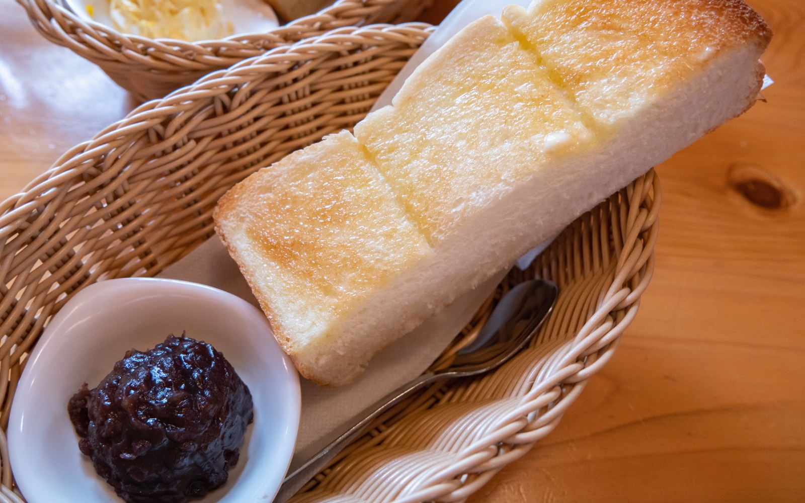 A slice of thick toast topped with sweet red bean paste, known as ogura toast