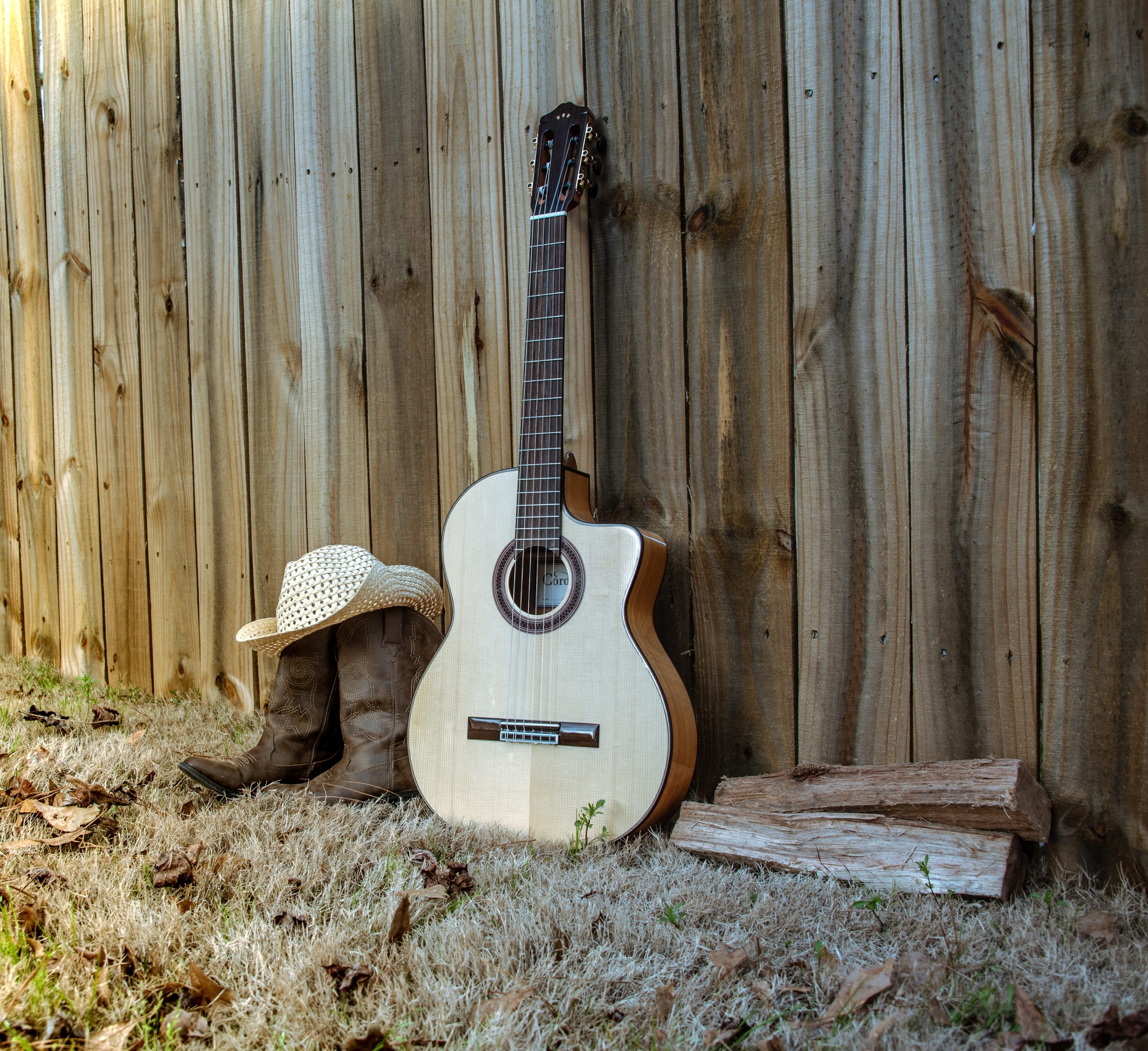 Old guitar cowboy hat in Texas on wooden background