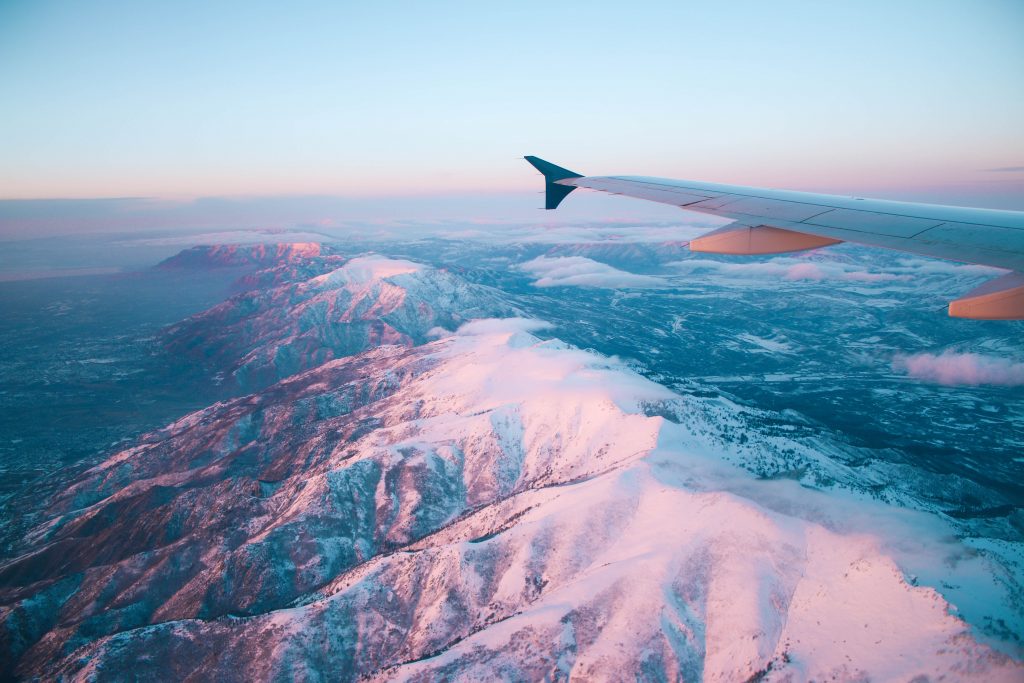 First time flying and seeing the world from above with a view of the plane's wing