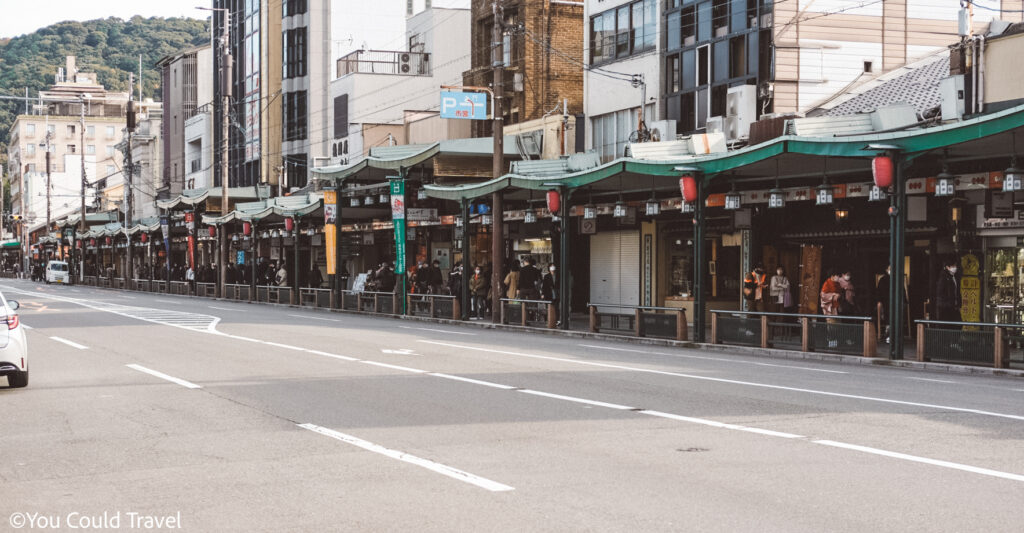 People walking in front of shops lined on Shijo Dori