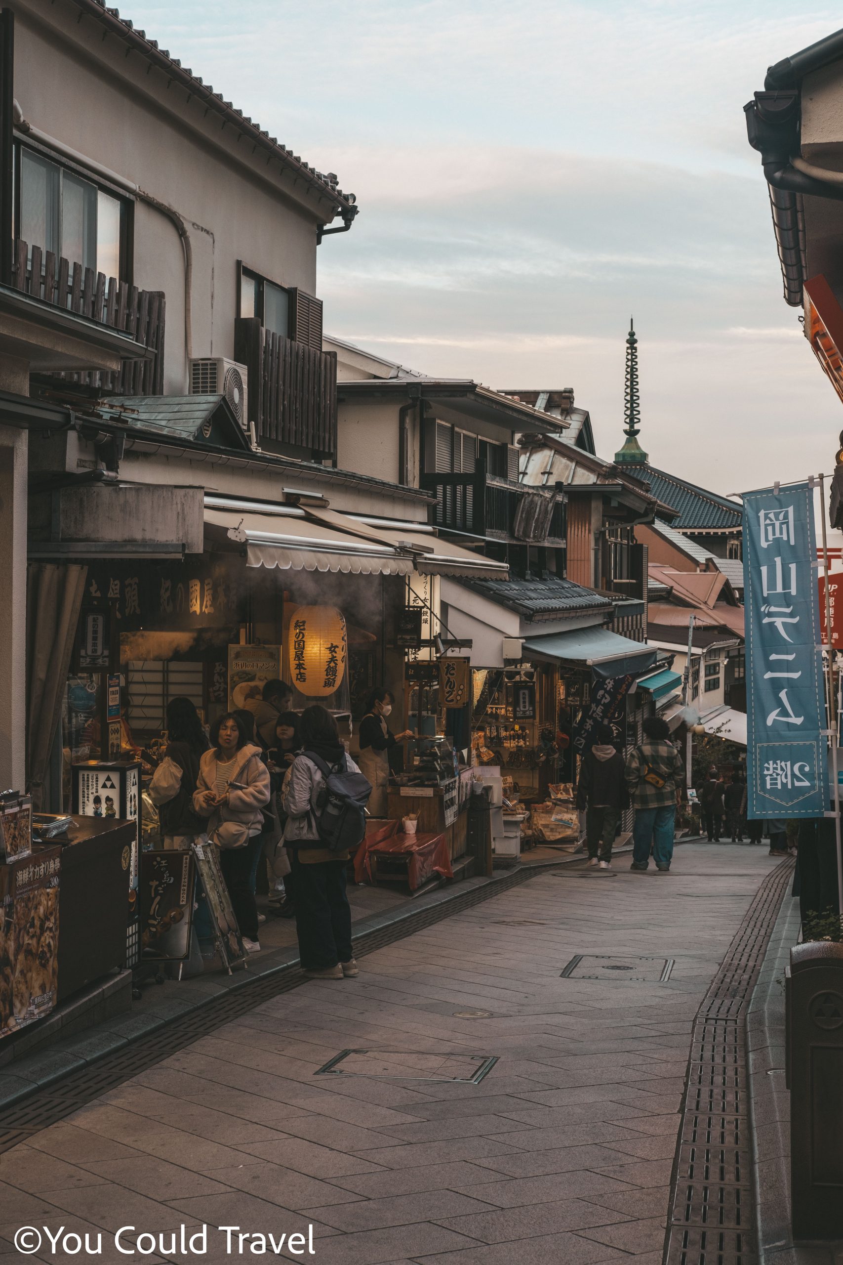 Purchasing souvenirs from Benzaiten Nakamise Dori