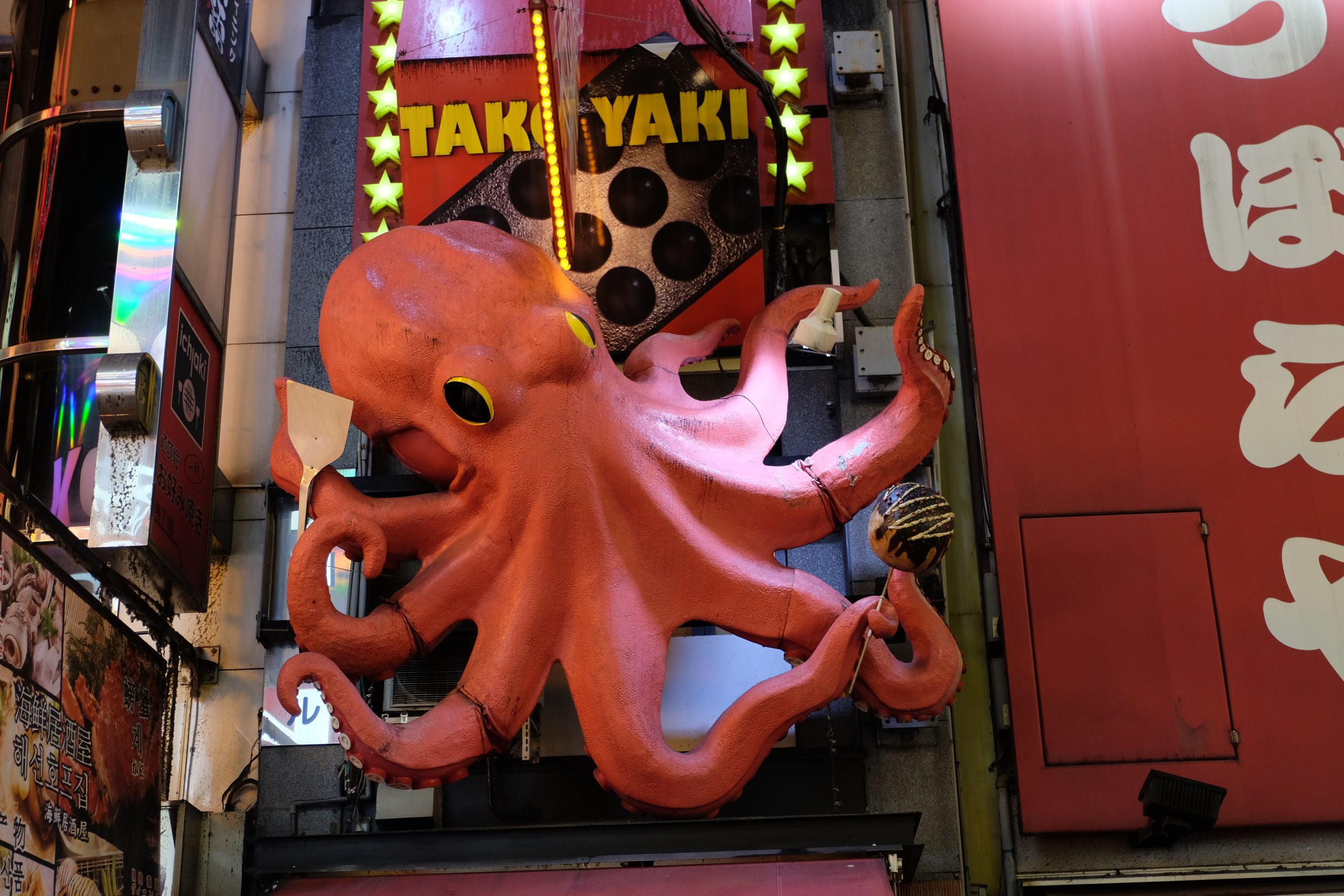 Restaurant advertising takoyaki with a large octopus mascot