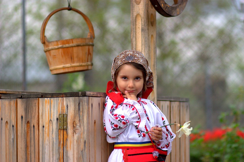 A Romanian dressed in Romanian clothes who speaks the Romanian language