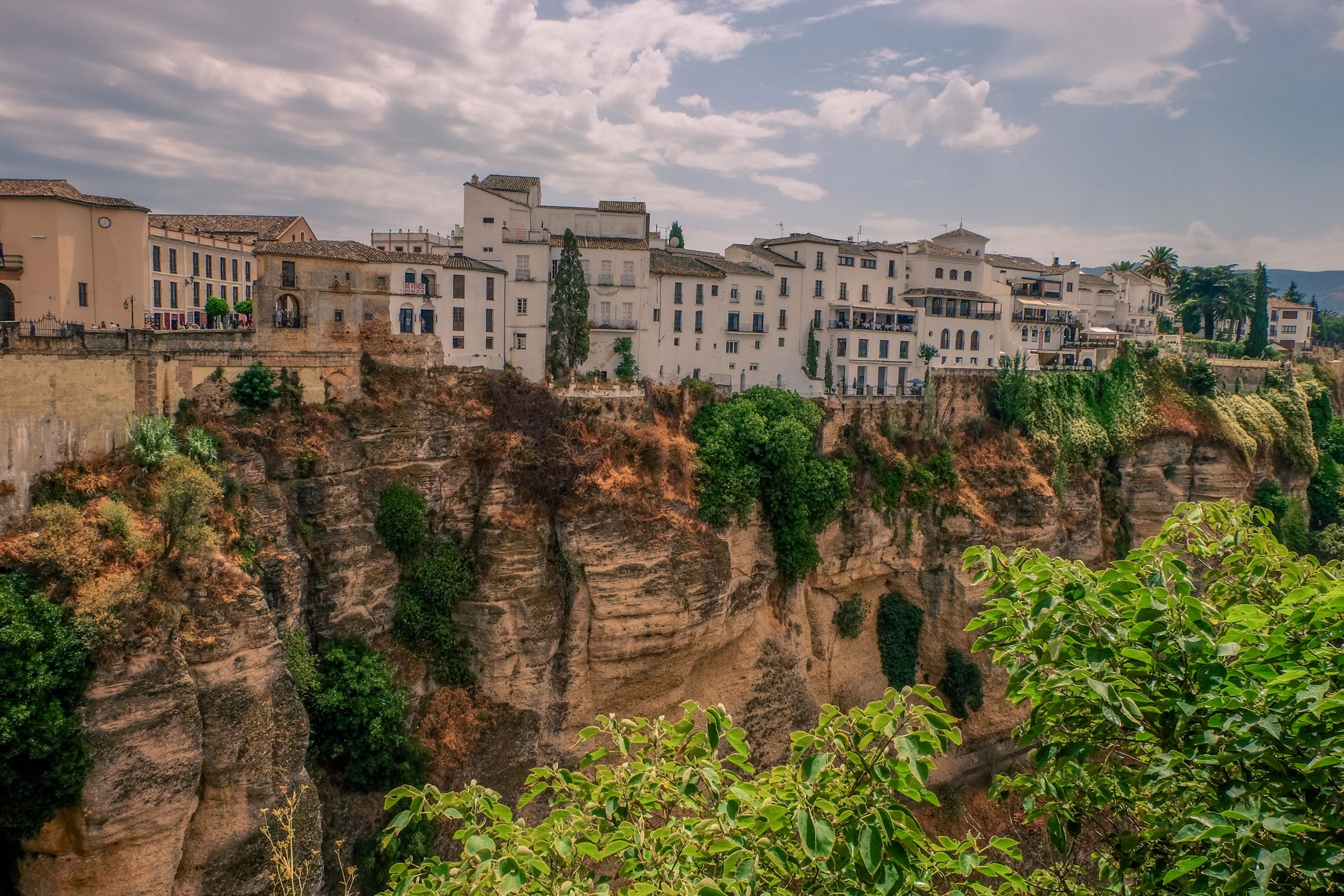 The view of Spanish houses located on the steep slopes of Ronda The view of Spanish houses located on the steep slopes of Ronda