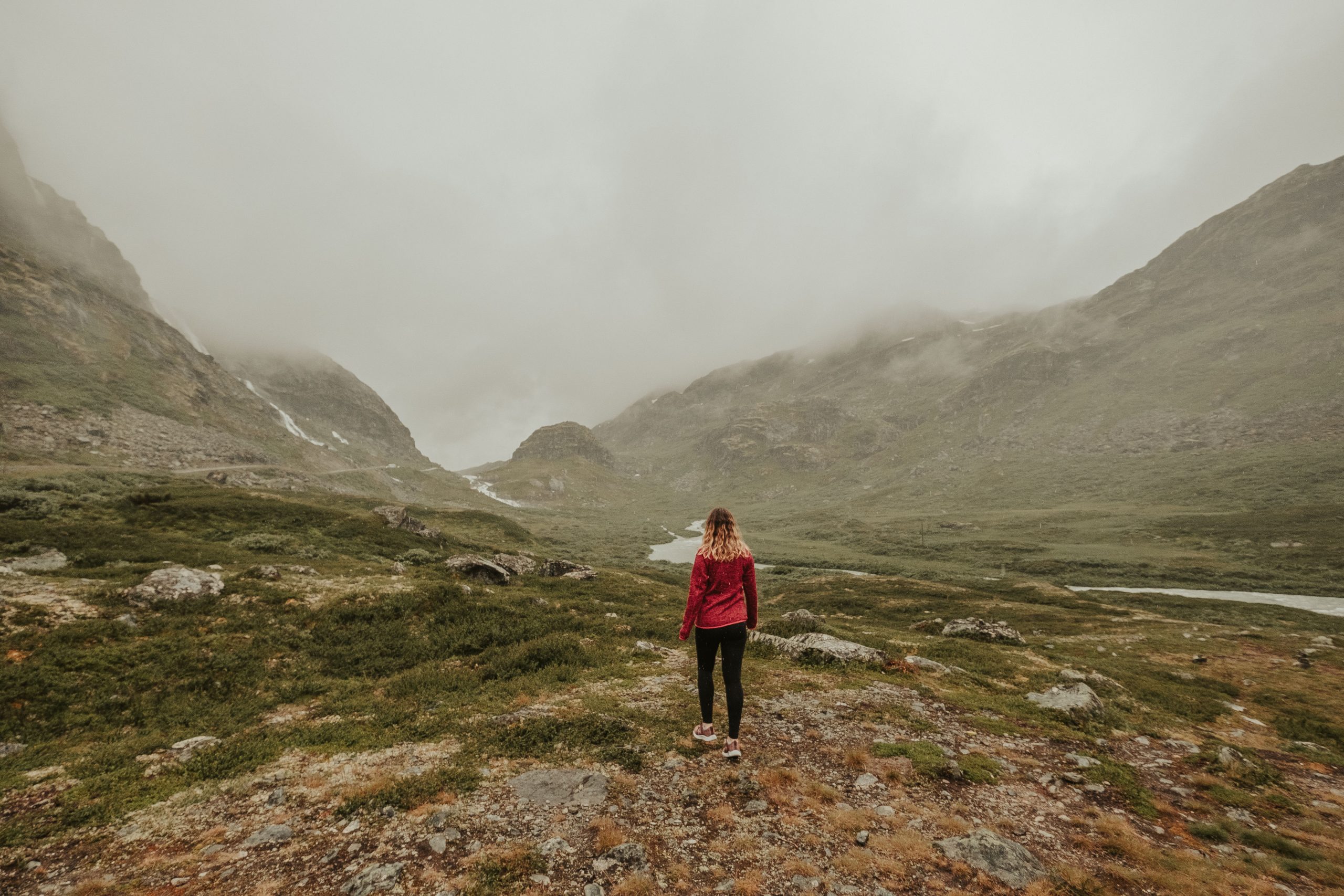 Cory from You Could Travel walking on rugged landscape in Norway