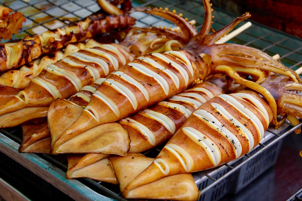 Freshly grilled squid on skewers for sale at Tsukiji market