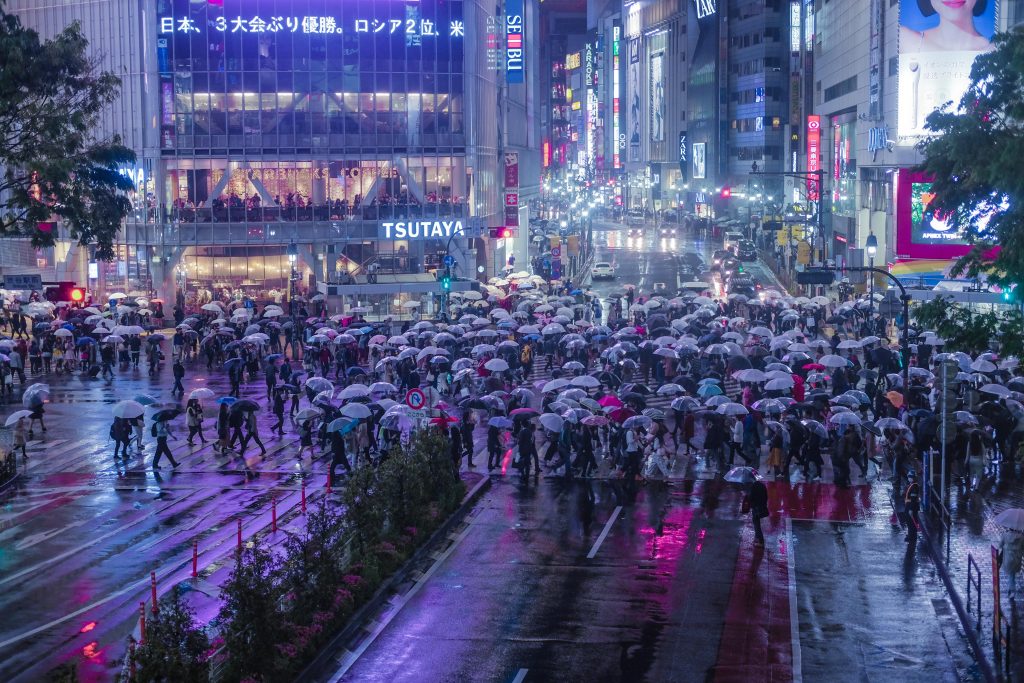 People crossing the famed Shibuya Crossing at night