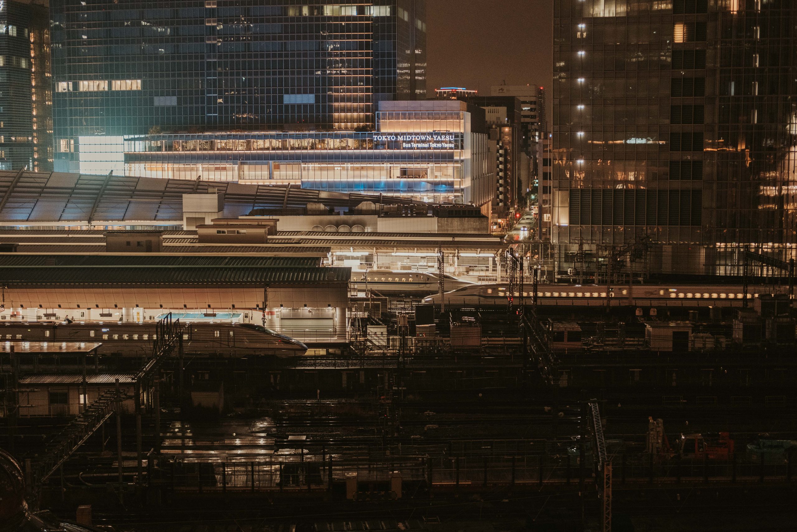 Shinkansen going in and out of the train station