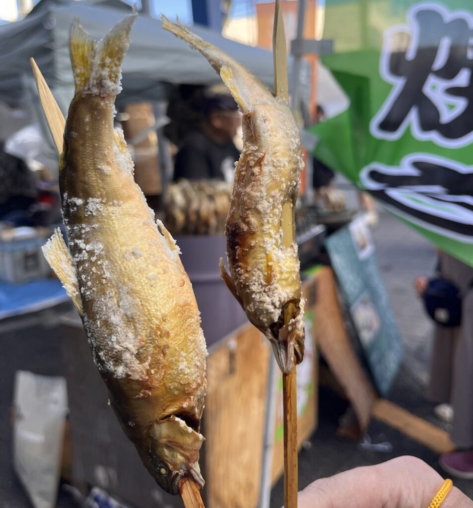 Shioyaki is grilled fish with salt on skewers as street food in Japan