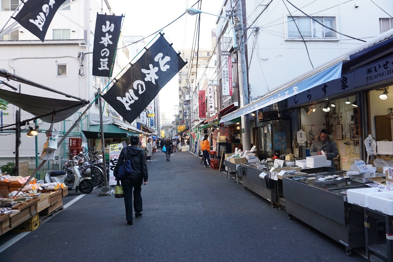 Man walking along the Tsukiji Outer Market first thing in the morning