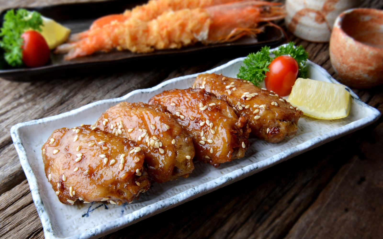 Deep-fried chicken wings, known as tebasaki, with dipping sauces