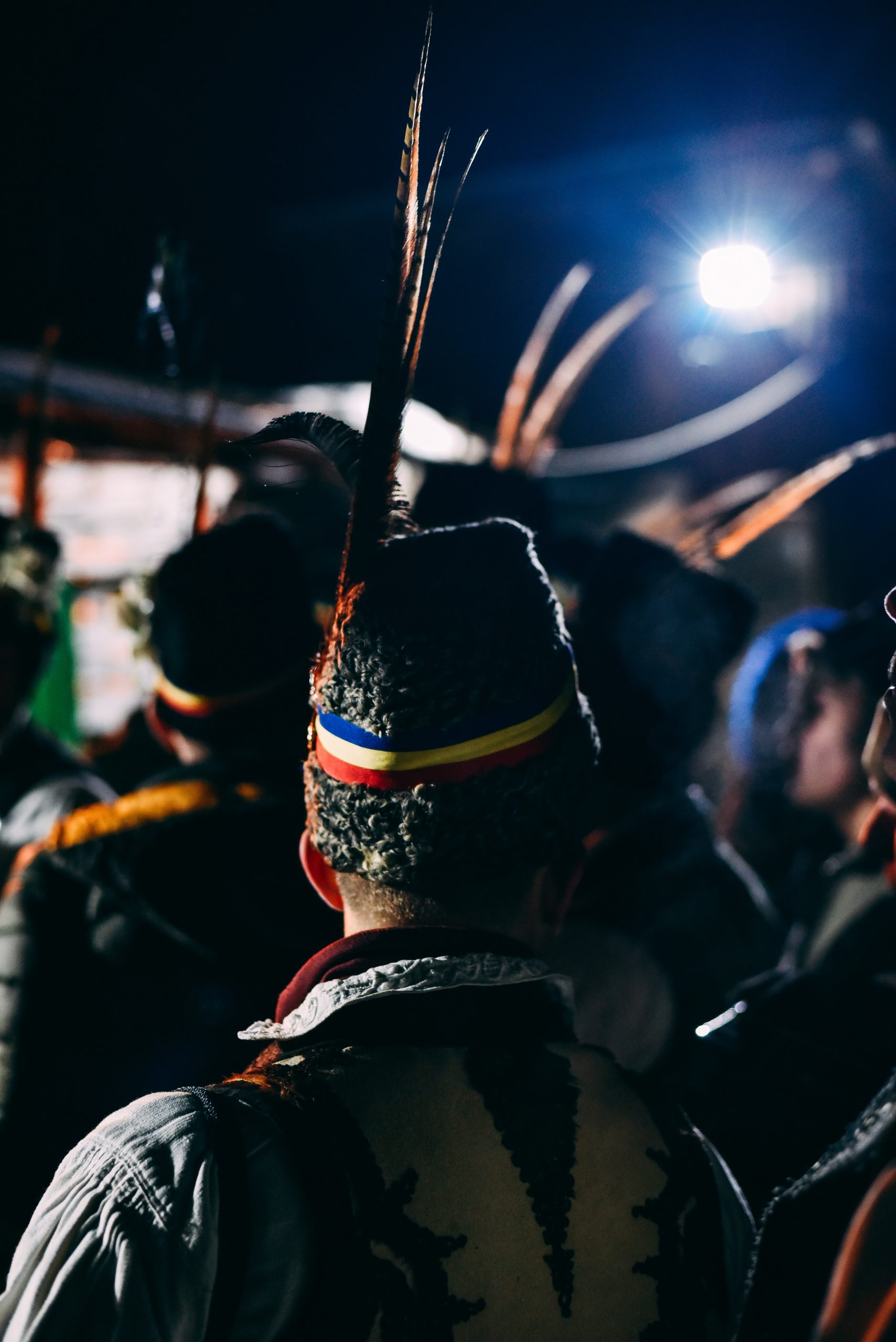 Romanian man wearing a traditions hat with the flag and a feather