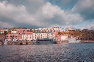 Views of the harbourside in Bristol, UK with colourful houses and the gran barge